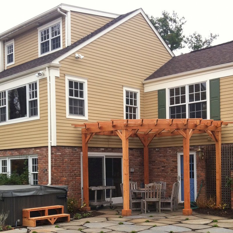 Custom Wooden Pergola (Options: 16' L, 14' W, Mature Redwood, No Electrical Wiring Trim, Open Roof with Slats at 18", Rafters at 18", Lengthwise Roof Support Timbers, 4-Post Anchor Kit for Stone, No Privacy Panels, No Curtain Rods, 9ft Post Height, Transparent Premium Sealant ). Photo Courtesy of Deborah Pasik of Morristown, New Jersey. Custom Wooden Pergola (Options: 16' L, 14' W, Mature Redwood, No Electrical Wiring Trim, Open Roof with Slats at 18", Rafters at 18", Lengthwise Roof Support Timbers, 4-Post Anchor Kit for Stone, No Privacy Panels, No Curtain Rods, 9ft Post Height, Transparent Premium Sealant ). Photo Courtesy of Deborah Pasik of Morristown, New Jersey.