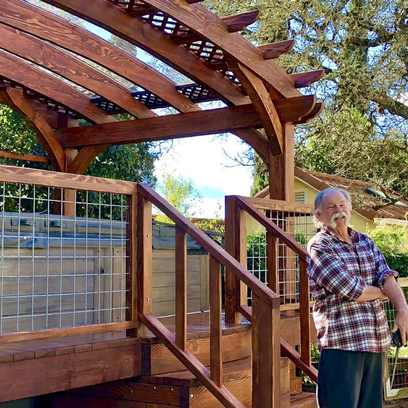 Custom Arched Pergola Kits (Options: 12' L x 22' Arc W, Douglas-fir, Unattached, Electrical Wiring Trim Kit for 1 Post, Arched Roof with Lattice Panels and Acrylic Sheets Centered, 4 Post Anchor Kit for Stone, with 8 x 8 Posts by Custom Request, No Ceiling Fan Base, No Privacy Panels, 1 Curtain Rod, 9' Post Height, Coffee-Stain Premium Sealant) with Custom Deck and Stairs by Custom Request. Photo Courtesy of Steve & Heidi Jones of Windsor, CA. Custom Arched Pergola Kits (Options: 12' L x 22' Arc W, Douglas-fir, Unattached, Electrical Wiring Trim Kit for 1 Post, Arched Roof with Lattice Panels and Acrylic Sheets Centered, 4 Post Anchor Kit for Stone, with 8 x 8 Posts by Custom Request, No Ceiling Fan Base, No Privacy Panels, 1 Curtain Rod, 9' Post Height, Coffee-Stain Premium Sealant) with Custom Deck and Stairs by Custom Request. Photo Courtesy of Steve & Heidi Jones of Windsor, CA.