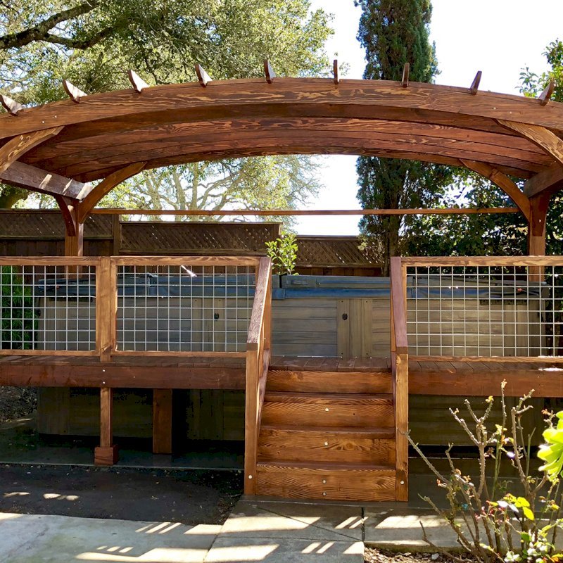 Custom Arched Pergola Kits (Options: 12' L x 22' Arc W, Douglas-fir, Unattached, Electrical Wiring Trim Kit for 1 Post, Arched Roof with Lattice Panels and Acrylic Sheets Centered, 4-Post Anchor Kit for Stone, with 8 x 8 Posts by Custom Request, No Ceiling Fan Base, No Privacy Panels, 1 Curtain Rod, 9' Post Height, Coffee-Stain Premium Sealant) with Custom Deck and Stairs by Custom Request. Photo Courtesy of Steve & Heidi Jones of Windsor, CA. Custom Arched Pergola Kits (Options: 12' L x 22' Arc W, Douglas-fir, Unattached, Electrical Wiring Trim Kit for 1 Post, Arched Roof with Lattice Panels and Acrylic Sheets Centered, 4-Post Anchor Kit for Stone, with 8 x 8 Posts by Custom Request, No Ceiling Fan Base, No Privacy Panels, 1 Curtain Rod, 9' Post Height, Coffee-Stain Premium Sealant) with Custom Deck and Stairs by Custom Request. Photo Courtesy of Steve & Heidi Jones of Windsor, CA.