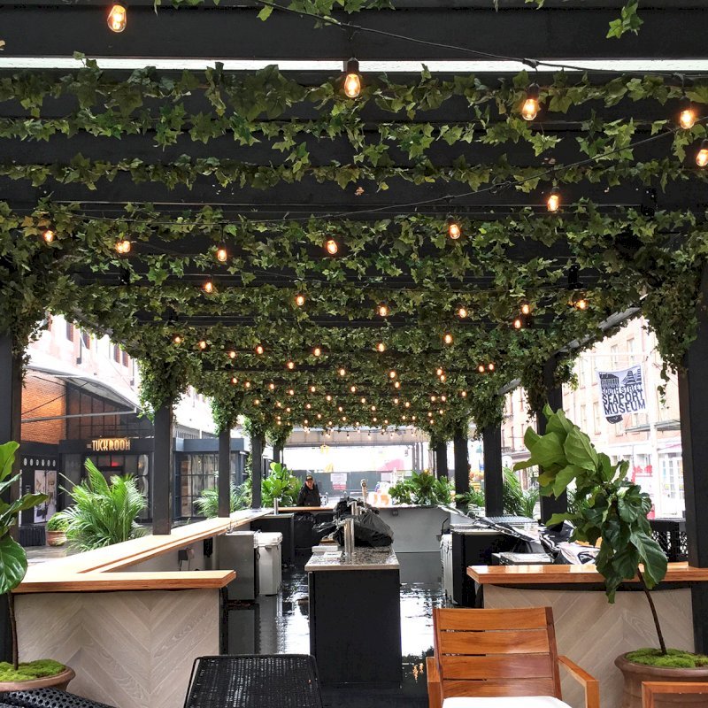 Custom Wooden Pergola (Options: 82' L x 16' W, Douglas-fir, Open Roof with Rafters at 18", with Transparent Rain Guard, 12-Post Anchor Kit, No Ceiling Fan Base, 12' Post Height, Custom Black Paint). This pergola is part of the giant popup beer hall at the Southside Seaport in downtown Manhattan from May to Oct 2017: https://www.timeout.com/newyork/blog/a-giant-pop-up-beer-hall-is-opening-at-south-street-seaport-this-summer-032417 Custom Wooden Pergola (Options: 82' L x 16' W, Douglas-fir, Open Roof with Rafters at 18", with Transparent Rain Guard, 12-Post Anchor Kit, No Ceiling Fan Base, 12' Post Height, Custom Black Paint). This pergola is part of the giant popup beer hall at the Southside Seaport in downtown Manhattan from May to Oct 2017: https://www.timeout.com/newyork/blog/a-giant-pop-up-beer-hall-is-opening-at-south-street-seaport-this-summer-032417