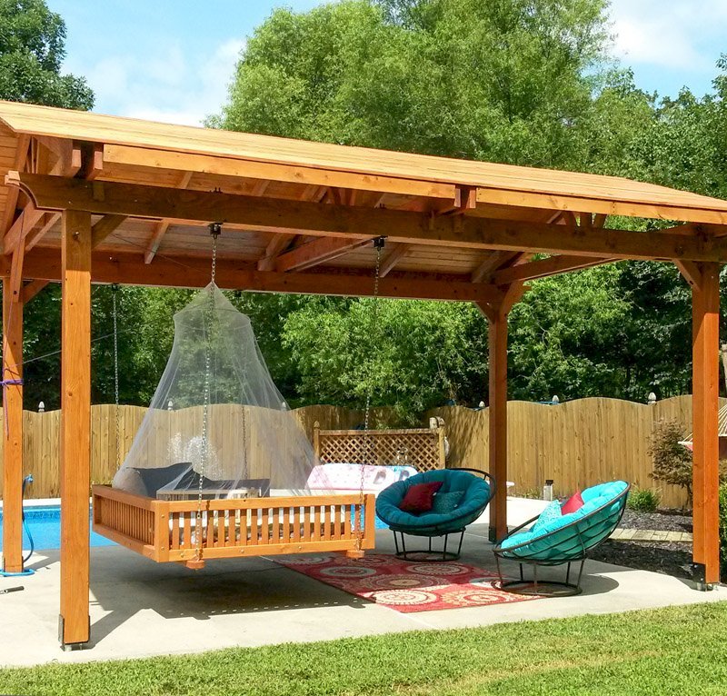 Del Norte Outdoor Kitchen Pavilion (Options: 18' L x 12' Triangle Base W, California Redwood, Unattached, 4 Post Anchor Kit for Stone, Brick or Concrete, No Electrical Wiring, 9 ft Post Height, No Ceiling Fan Bse, No Privacy Panels, 4 Curtain Rods,Transparent Sealant) with a Custom Day Bed. Photo Courtesy of Kym C. of Charlotte, NC. Del Norte Outdoor Kitchen Pavilion (Options: 18' L x 12' Triangle Base W, California Redwood, Unattached, 4 Post Anchor Kit for Stone, Brick or Concrete, No Electrical Wiring, 9 ft Post Height, No Ceiling Fan Bse, No Privacy Panels, 4 Curtain Rods,Transparent Sealant) with a Custom Day Bed. Photo Courtesy of Kym C. of Charlotte, NC.