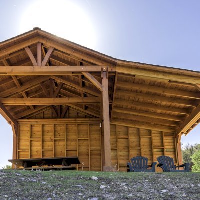 Custom Del Norte Outdoor Kitchen Pavilion (Options: 12' L x 12' W, with 9' x 12' Shed Pavilion Attached, Douglas-fir, 6-Post Anchor Kit for High-Wind, No Ceiling Fan Base, No Electrical Wiring Trim Kit, No Post Decorative Trims, with Custom Solid Wall, Transparent Premium Sealant). Photo Courtesy of J. Randall of Warner Springs, CA.