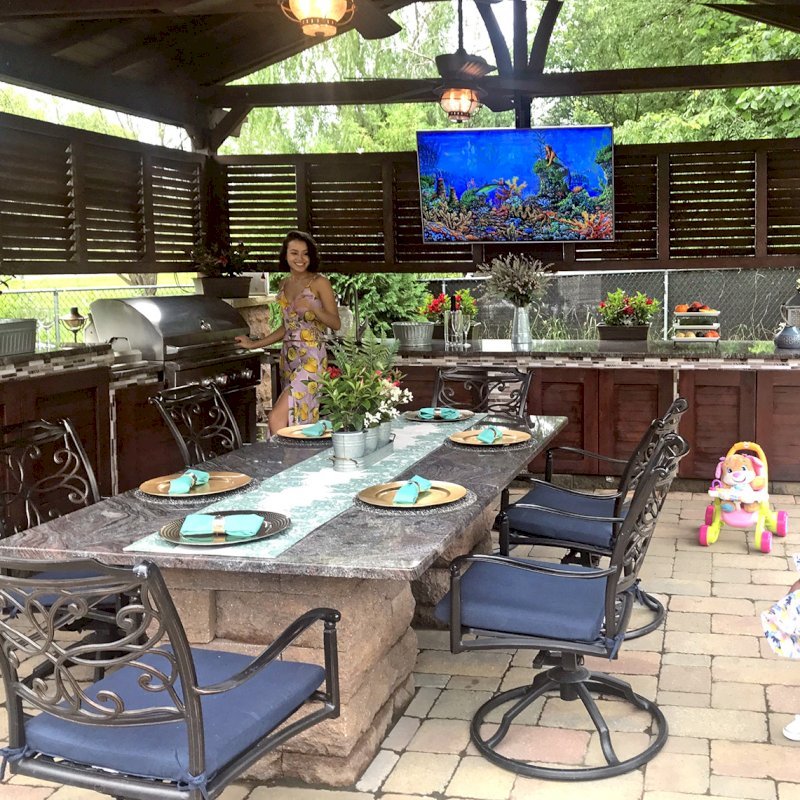 Del Norte Outdoor Kitchen Pavilion (Options: 20' L x 18' W, Mature Redwood, 4-Post Kit for Gale-Wind, 2 Ceiling Fan Bases, 2 Electrical Wiring Trim Kits, 2 Sets of Louvers on 2 Sides, No Post Decorative Trims, 9' H Posts Wrapped in Stone After Installation, Coffee-Stain Premium Sealant). Photo Courtesy of Shawn and Marilyn Murray of Walden, New York. Del Norte Outdoor Kitchen Pavilion (Options: 20' L x 18' W, Mature Redwood, 4-Post Kit for Gale-Wind, 2 Ceiling Fan Bases, 2 Electrical Wiring Trim Kits, 2 Sets of Louvers on 2 Sides, No Post Decorative Trims, 9' H Posts Wrapped in Stone After Installation, Coffee-Stain Premium Sealant). Photo Courtesy of Shawn and Marilyn Murray of Walden, New York.