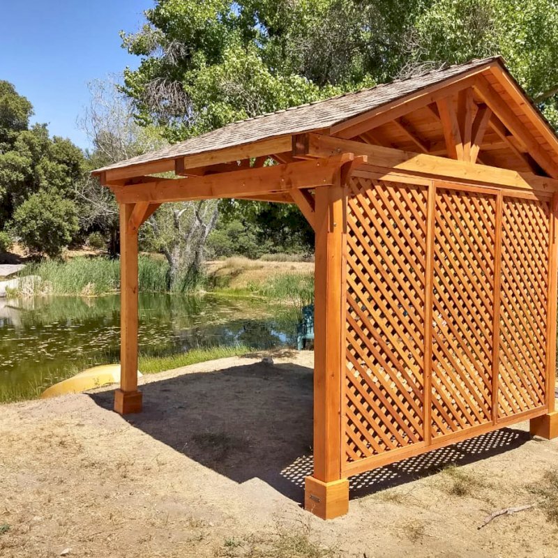 Del Norte Outdoor Kitchen Pavilion (Options: 12' L x 12' W, 1 Full Wall Lattice Privacy Panel, Douglas-fir, 4-Post Kit for Gale-Wind, No Ceiling Fan Base, No Electrical Wiring Trim Kit, No Post Decorative Trims, Transparent Premium Sealant). Photo Courtesy of J. Randall of Warner Springs, CA. Del Norte Outdoor Kitchen Pavilion (Options: 12' L x 12' W, 1 Full Wall Lattice Privacy Panel, Douglas-fir, 4-Post Kit for Gale-Wind, No Ceiling Fan Base, No Electrical Wiring Trim Kit, No Post Decorative Trims, Transparent Premium Sealant). Photo Courtesy of J. Randall of Warner Springs, CA.