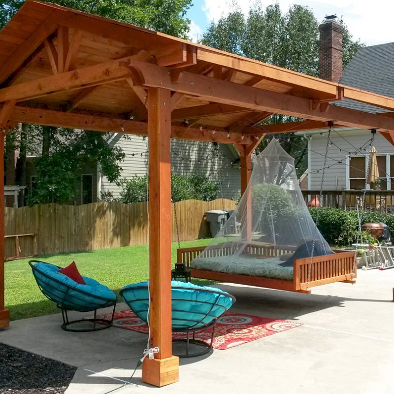 Del Norte Outdoor Kitchen Pavilion (Options: 18' L x 12' Triangle Base W, California Redwood, Unattached, 4 Post Anchor Kit for Stone, Brick or Concrete, No Electrical Wiring, 9 ft Post Height, No Ceiling Fan Bse, No Privacy Panels, 4 Curtain Rods,Transparent Sealant) with a Custom Day Bed. Photo Courtesy of Kym C. of Charlotte, NC. Del Norte Outdoor Kitchen Pavilion (Options: 18' L x 12' Triangle Base W, California Redwood, Unattached, 4 Post Anchor Kit for Stone, Brick or Concrete, No Electrical Wiring, 9 ft Post Height, No Ceiling Fan Bse, No Privacy Panels, 4 Curtain Rods,Transparent Sealant) with a Custom Day Bed. Photo Courtesy of Kym C. of Charlotte, NC.
