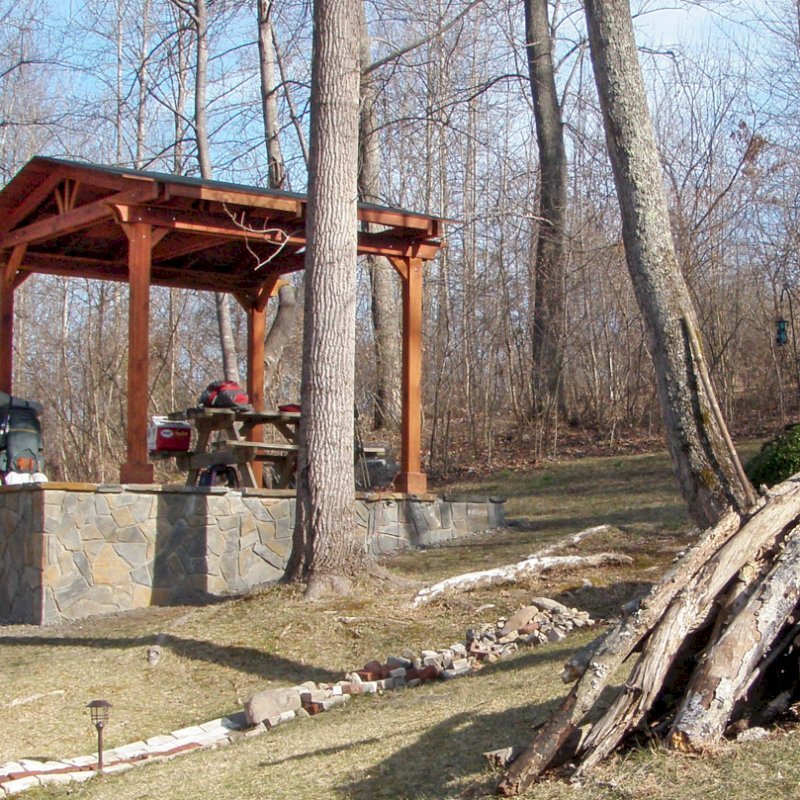 Del Norte Outdoor Kitchen Pavilion (Options: 12' L x 12' W, Mature Redwood, Unattached, 4-post Kit for Stone, No Electrical Wiring Trim, 9' Posts, No Ceiling Fan Base, No Privacy Panels, No Curtain Rods, Transparent Premium Sealant). Photo Courtesy of Lisa K. & Peter S. of Lexington, VA. Del Norte Outdoor Kitchen Pavilion (Options: 12' L x 12' W, Mature Redwood, Unattached, 4-post Kit for Stone, No Electrical Wiring Trim, 9' Posts, No Ceiling Fan Base, No Privacy Panels, No Curtain Rods, Transparent Premium Sealant). Photo Courtesy of Lisa K. & Peter S. of Lexington, VA.