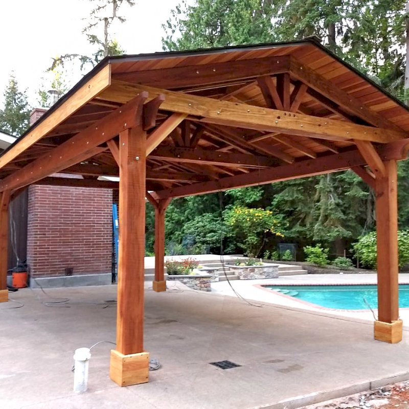 Custom Del Rio Cathedral Ceiling Thick Timber Pavilion (Options: 22' L x 15' W, California Redwood, 4-Post Kit for Hurricane, Electrical Wiring Trim for 2 Posts, 9.5' Posts, 1 Ceiling Fan Base, No Privacy Panels, No Curtain Rods, Transparent Premium Sealant). Photo Courtesy of S. Flanagin of Sammamish, Washington. Custom Del Rio Cathedral Ceiling Thick Timber Pavilion (Options: 22' L x 15' W, California Redwood, 4-Post Kit for Hurricane, Electrical Wiring Trim for 2 Posts, 9.5' Posts, 1 Ceiling Fan Base, No Privacy Panels, No Curtain Rods, Transparent Premium Sealant). Photo Courtesy of S. Flanagin of Sammamish, Washington.