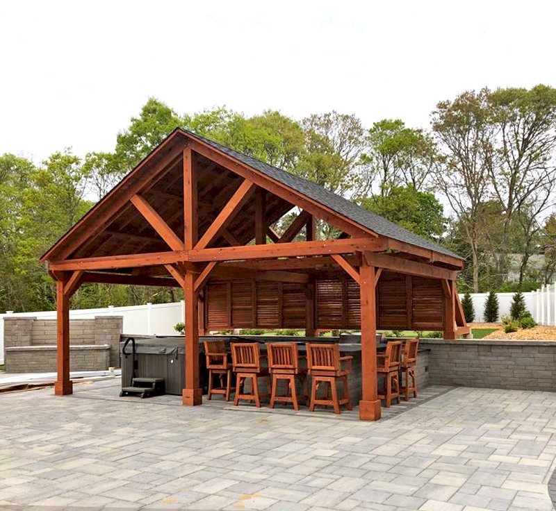 Del Rio Cathedral Ceiling Thick Timber Pavilion (Options: 18' L x 26' W, California Redwood, 6-Post Kit for Concrete, Electrical Wiring Trim for 2 Posts, 9.5' Posts, 2 Ceiling Fan Bases, No Privacy Panels, No Curtain Rods, Transparent Premium Sealant, with Extra Knee Braces on the Back by Custom Request). Photo Courtesy of B. Poutre of North Falmouth, Massachusetts. Del Rio Cathedral Ceiling Thick Timber Pavilion (Options: 18' L x 26' W, California Redwood, 6-Post Kit for Concrete, Electrical Wiring Trim for 2 Posts, 9.5' Posts, 2 Ceiling Fan Bases, No Privacy Panels, No Curtain Rods, Transparent Premium Sealant, with Extra Knee Braces on the Back by Custom Request). Photo Courtesy of B. Poutre of North Falmouth, Massachusetts.