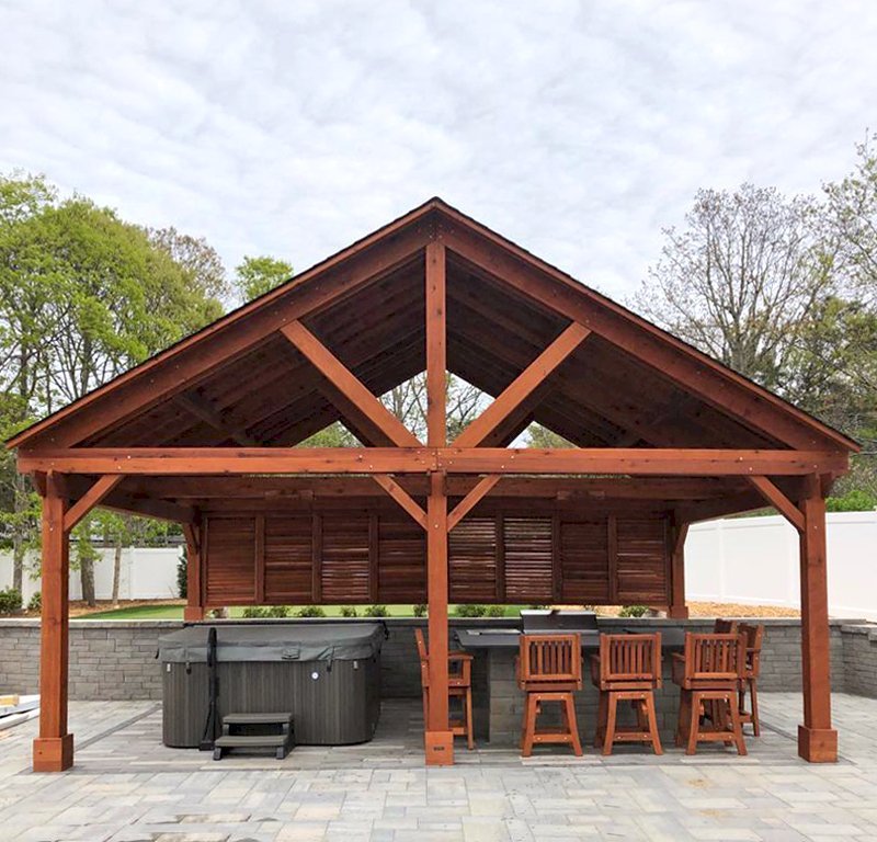Del Rio Cathedral Ceiling Thick Timber Pavilion (Options: 18' L x 26' W, California Redwood, 6-Post Kit for Concrete, Electrical Wiring Trim for 2 Posts, 9.5' Posts, 2 Ceiling Fan Bases, No Privacy Panels, No Curtain Rods, Transparent Premium Sealant, with Extra Knee Braces on the Back by Custom Request). Photo Courtesy of B. Poutre of North Falmouth, Massachusetts. Del Rio Cathedral Ceiling Thick Timber Pavilion (Options: 18' L x 26' W, California Redwood, 6-Post Kit for Concrete, Electrical Wiring Trim for 2 Posts, 9.5' Posts, 2 Ceiling Fan Bases, No Privacy Panels, No Curtain Rods, Transparent Premium Sealant, with Extra Knee Braces on the Back by Custom Request). Photo Courtesy of B. Poutre of North Falmouth, Massachusetts.