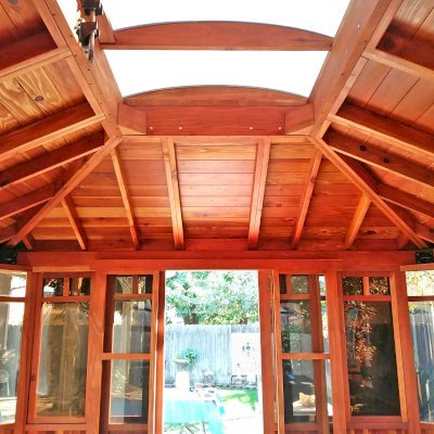 DIY Wood Gazebo (14' L, 12' W, California Redwood, All Sliding Windows with Screens, 4' x 6' Skylight, 36" H Siding Below Windows, Vertical Siding, Japanese Doors with Screens, No Flooring, Transparent Premium Sealant). Photo Courtesy of B. Adkisson of Sacramento, CA. XL Custom Roof per Customer Request.