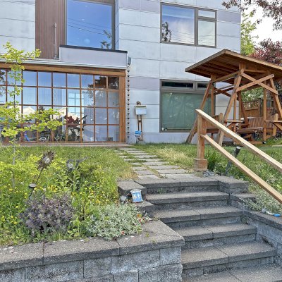 Dustin's Face to Face Glider (Options: Douglas-fir, Custom Flat XW Roof, With Beverage Armrest, No Kid's Platform, No Engraving, Transparent Premium Sealant). Photo Also Shows a Custom Sunroom Gazebo. Photo Courtesy of M. Frasch of Seattle, WA.