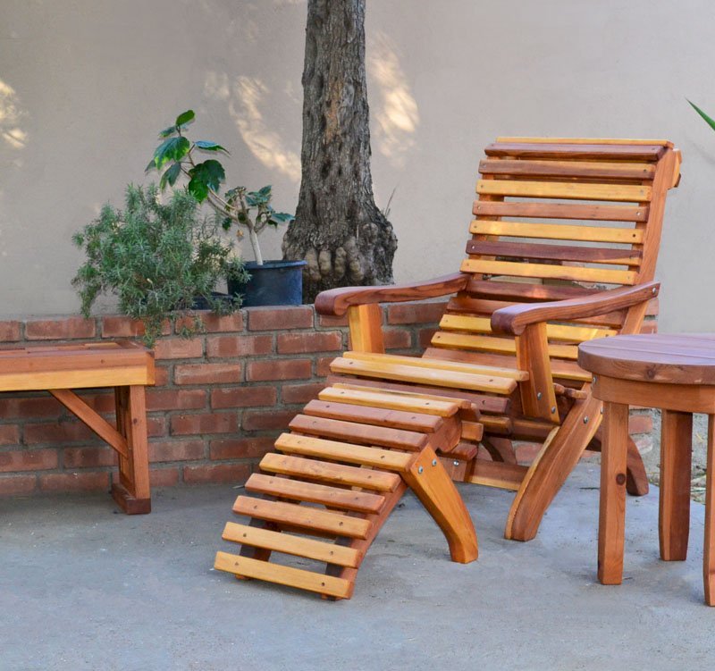 Ensenada Wood Easy Chair (Options: Standard Size, California Redwood, No Cushion, Ottoman, Transparent Premium Sealant). Photo also shows a round side table and a lighthouse bench. Ensenada Wood Easy Chair (Options: Standard Size, California Redwood, No Cushion, Ottoman, Transparent Premium Sealant). Photo also shows a round side table and a lighthouse bench.