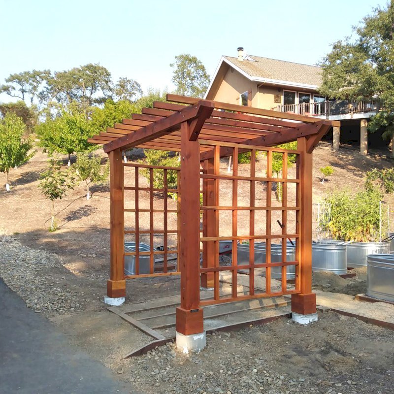 Custom Entryway Arbor (Options: 120" W, 84" D, California Redwood, 4-Post Archor Kit for Concrete, Transparent Premium Sealant) with 6 x 6 Posts and 2 x 6 Rafters by Custom Request. Photo Courtesy of K. Moore of Healdsburg, CA. Custom Entryway Arbor (Options: 120" W, 84" D, California Redwood, 4-Post Archor Kit for Concrete, Transparent Premium Sealant) with 6 x 6 Posts and 2 x 6 Rafters by Custom Request. Photo Courtesy of K. Moore of Healdsburg, CA.
