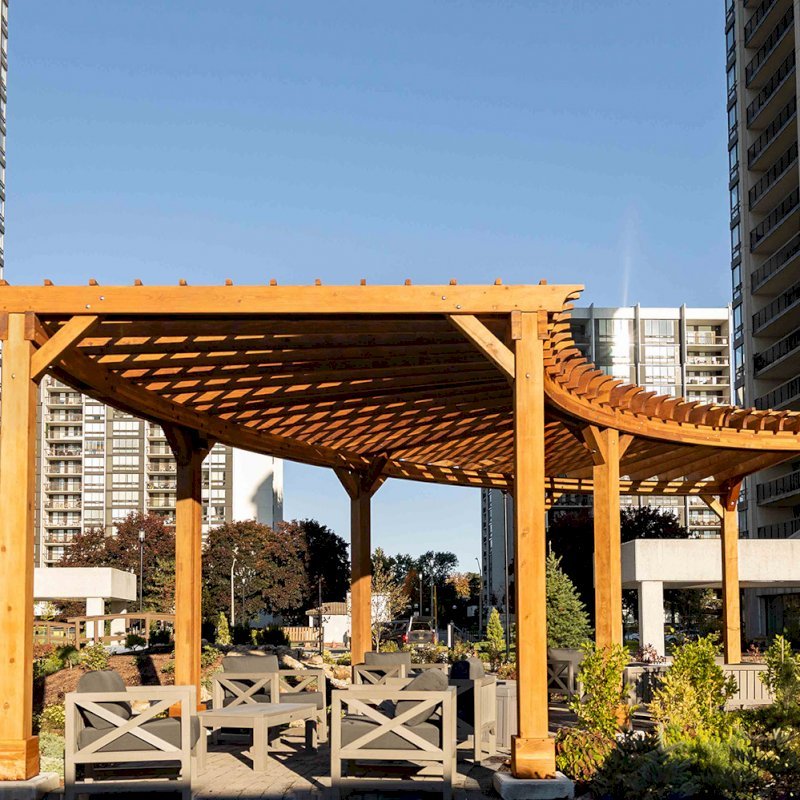 Fan Shaped Pergola Kit (Options: 38' x 14', California Redwood, With Roof Slats, 1 Electrical Wiring Trim Kit, 8-Post Anchor Kit for High-Wind, No Ceiling Fan Base, 10' Posts, No Curtain Rods, Transparent Premium Sealant). Photo Courtesy of A. Finnegan of Toronto, Ontario, Canada. Fan Shaped Pergola Kit (Options: 38' x 14', California Redwood, With Roof Slats, 1 Electrical Wiring Trim Kit, 8-Post Anchor Kit for High-Wind, No Ceiling Fan Base, 10' Posts, No Curtain Rods, Transparent Premium Sealant). Photo Courtesy of A. Finnegan of Toronto, Ontario, Canada.