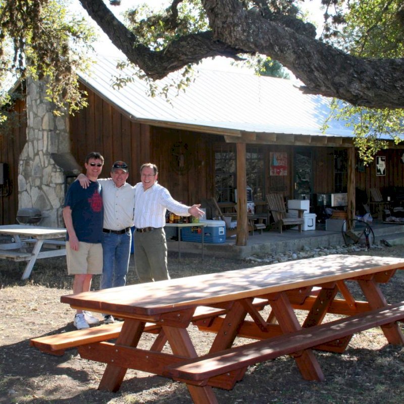 Forever Picnic Tables (Attached Benches) (Options: 12' L, 34 1/2" W, Side Benches, Mature Redwood, Standard Tabletop, Slightly Rounded Corners, No Umbrella Hole, Transparent Premium Sealant). Photo Courtesy of Mr. Pat Ankney, W&M Ranch, Camp Wood, TX. Forever Picnic Tables (Attached Benches) (Options: 12' L, 34 1/2" W, Side Benches, Mature Redwood, Standard Tabletop, Slightly Rounded Corners, No Umbrella Hole, Transparent Premium Sealant). Photo Courtesy of Mr. Pat Ankney, W&M Ranch, Camp Wood, TX.