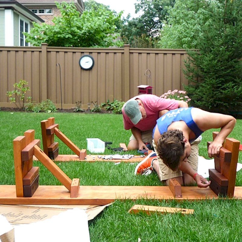 Assembly of a Heritage Picnic Table (Options: 12' L, 34 1/2" W, Side Benches, 2 Half Length Side Benches/Side, Classic Forever Benches, Standard Tabletop, Slightly Rounded Corners, Standard Leg Flair, No Umbrella Hole, Transparent Premium Sealant). Photo Courtesy of Pat Meyer of River Forest, Illinois. Assembly of a Heritage Picnic Table (Options: 12' L, 34 1/2" W, Side Benches, 2 Half Length Side Benches/Side, Classic Forever Benches, Standard Tabletop, Slightly Rounded Corners, Standard Leg Flair, No Umbrella Hole, Transparent Premium Sealant). Photo Courtesy of Pat Meyer of River Forest, Illinois.