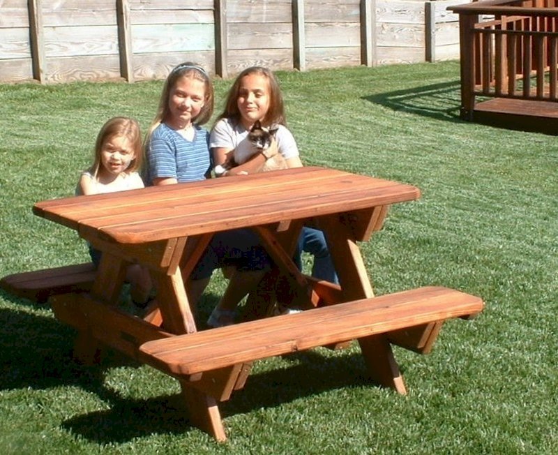 Kid Size Wood Picnic Table (Attached Benches) (Options: Mature Redwood, No Umbrella, Standard Top, Transparent Premium Sealant). Custom design: rounded corners and thickness of the bars of the table are thinner than standard. Photo Courtesy of Rachel & Tim McAllister of Santa Rosa, CA. Kid Size Wood Picnic Table (Attached Benches) (Options: Mature Redwood, No Umbrella, Standard Top, Transparent Premium Sealant). Custom design: rounded corners and thickness of the bars of the table are thinner than standard. Photo Courtesy of Rachel & Tim McAllister of Santa Rosa, CA.
