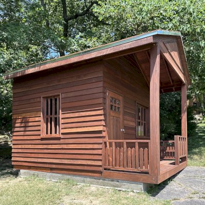 Kid's Backyard Cabin (Options: 14ft L x 10ft W, 8ft Wall H, Douglas-fir [Exterior Siding & Roofing in California Redwood by Custom Request], 4ft Front Porch Size [Included in the Overall Length], Interior Tongue & Groove Flooring, Shiplap Roof, Coffee-Stain Premium Sealant). Photo Courtesy of T. ONeill of Kimberling City, MO.