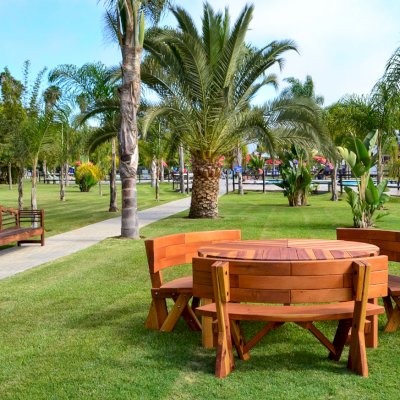 Lisa's Retro Outdoor Patio Table (Options: 5' Diameter, California Redwood, Custom Fullback Arc Benches, Standard Tabletop, No Lazy Susan, Umbrella Hole, Transparent Premium Sealant). Photo also shows Lutyens Bench in background.