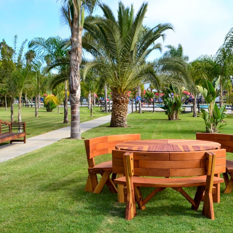 Lisa's Retro Outdoor Patio Table (Options: 5' Diameter, California Redwood, Custom Fullback Arc Benches, Standard Tabletop, No Lazy Susan, Umbrella Hole, Transparent Premium Sealant). Photo also shows Lutyens Bench in background. Lisa's Retro Outdoor Patio Table (Options: 5' Diameter, California Redwood, Custom Fullback Arc Benches, Standard Tabletop, No Lazy Susan, Umbrella Hole, Transparent Premium Sealant). Photo also shows Lutyens Bench in background.