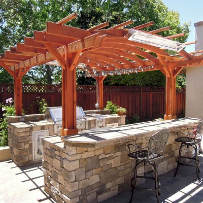 Marin Outdoor Kitchen Pergola (Options: 14' L x 16' Arc W, California Redwood, Unattached, 2 Post Electrical Wiring Trim, Arched Roof without Lattice Panels, 4-Post Anchor Kit for Stone, No Ceiling Fan Base, No Privacy, No Curtain Rods, 9 ft Post Height (front posts wrapped with masonry), Transparent Premium Sealant). 