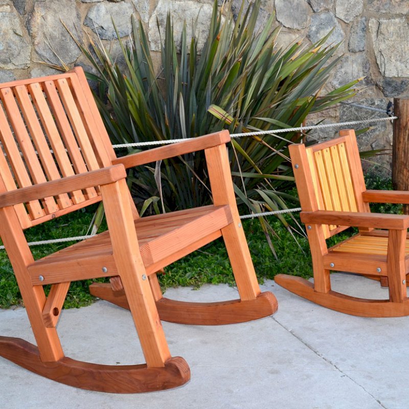 Massive Rocking Chair (Options: Standard Width, Tall, Mature Redwood, No Cushion, Transparent Premium Sealant). Photo Also Shows a Kid's Rocking Chair in California Redwood. Massive Rocking Chair (Options: Standard Width, Tall, Mature Redwood, No Cushion, Transparent Premium Sealant). Photo Also Shows a Kid's Rocking Chair in California Redwood.