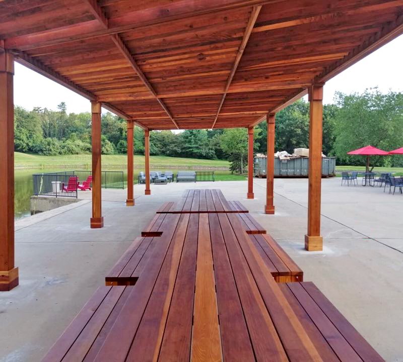 Maynard Modern Redwood Patio Table (Options: 15' L, 42" W Tabletop, Side Benches, California Redwood, 2 Half Length Maynard Benches Per Side, Standard Tabletop, No Umbrella Hole, Transparent Premium Sealant). Tables Under a Silverado Modern Pergola. Photo Courtesy of A. Arena of Morristown, New Jersey. Maynard Modern Redwood Patio Table (Options: 15' L, 42" W Tabletop, Side Benches, California Redwood, 2 Half Length Maynard Benches Per Side, Standard Tabletop, No Umbrella Hole, Transparent Premium Sealant). Tables Under a Silverado Modern Pergola. Photo Courtesy of A. Arena of Morristown, New Jersey.