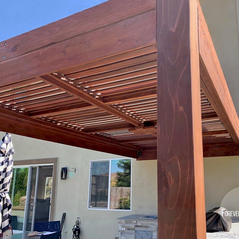 Modern Louvered Garden Pergola (Options: 16' L x 10' W, 8" x 8" Posts, Mobile Louvers, California Redwood, 9.5 ft H, 1 Electrical Wiring Trim, No Curtain Rods, 2 Post Anchor Kit for Concrete, Attached to Wall by Custom Request, No Post Decorative Trims, 1 Ceiling Fan Base, Coffee Stain Premium Sealant). Photo Courtesy of J. Murphy of Eldorado Hills, California. Modern Louvered Garden Pergola (Options: 16' L x 10' W, 8" x 8" Posts, Mobile Louvers, California Redwood, 9.5 ft H, 1 Electrical Wiring Trim, No Curtain Rods, 2 Post Anchor Kit for Concrete, Attached to Wall by Custom Request, No Post Decorative Trims, 1 Ceiling Fan Base, Coffee Stain Premium Sealant). Photo Courtesy of J. Murphy of Eldorado Hills, California.