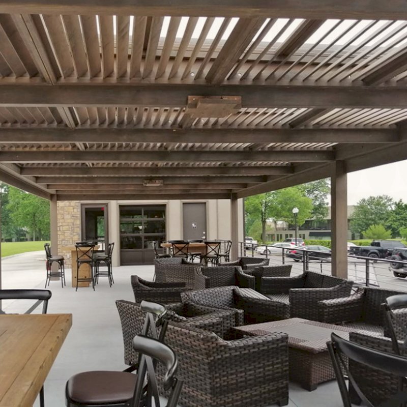 Modern Louvered Garden Pergola (Options: 44' L x 18' W, 8" x 8" Posts, Mobile Louvers, Douglas-fir, 10 ft H, No Electrical Wiring Trim, 4 Curtain Rods, 6 Post Anchor Kit for Concrete, With Clear Polycarbonate Roofing Atop Pergola Framing by Custom Request, No Post Decorative Trims, No Ceiling Fan Bases, Coffee-Stain Premium Sealant). Photo Courtesy of M. Hudson of Rogers, Arkansas. Modern Louvered Garden Pergola (Options: 44' L x 18' W, 8" x 8" Posts, Mobile Louvers, Douglas-fir, 10 ft H, No Electrical Wiring Trim, 4 Curtain Rods, 6 Post Anchor Kit for Concrete, With Clear Polycarbonate Roofing Atop Pergola Framing by Custom Request, No Post Decorative Trims, No Ceiling Fan Bases, Coffee-Stain Premium Sealant). Photo Courtesy of M. Hudson of Rogers, Arkansas.