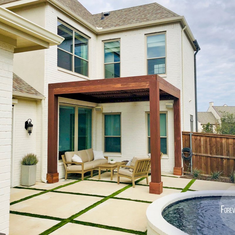 Custom Modern Louvered Garden Pergola (Options: 12' L x 12' W, 10" x 10" Posts, Mobile Louvers, California Redwood, 10 ft H, No Electrical Wiring Trim, 3 Post Anchor Kit for Concrete, No post decorative trims, No Ceiling Fan Base, Coffee-Stain Premium Sealant). The Modern Louvered Pergola can be altered to be attached to a building by eliminating one or more posts like this image shows. Photo Courtesy of S. Wottle of Frisco, Texas. Custom Modern Louvered Garden Pergola (Options: 12' L x 12' W, 10" x 10" Posts, Mobile Louvers, California Redwood, 10 ft H, No Electrical Wiring Trim, 3 Post Anchor Kit for Concrete, No post decorative trims, No Ceiling Fan Base, Coffee-Stain Premium Sealant). The Modern Louvered Pergola can be altered to be attached to a building by eliminating one or more posts like this image shows. Photo Courtesy of S. Wottle of Frisco, Texas.