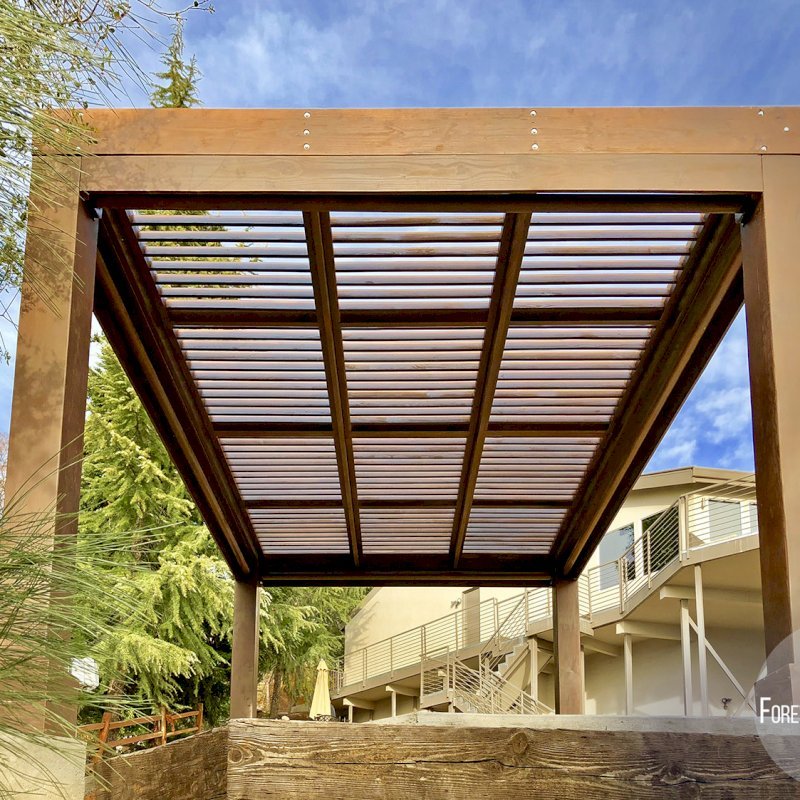 Modern Louvered Garden Pergola (Options: 16' L x 12' W, 10" x 10", Fixed Louvers, Douglas-fir, 9.5 ft H, No Electrical Wiring Trim Kit, 4 Post Anchor Kit for Concrete, No Post Decorative Trims, No Ceiling Fan Base, 4 Curtain Rods, Coffee Stain Sealant). Photo Courtesy of R. McCan of El Dorado Hills, CA Modern Louvered Garden Pergola (Options: 16' L x 12' W, 10" x 10", Fixed Louvers, Douglas-fir, 9.5 ft H, No Electrical Wiring Trim Kit, 4 Post Anchor Kit for Concrete, No Post Decorative Trims, No Ceiling Fan Base, 4 Curtain Rods, Coffee Stain Sealant). Photo Courtesy of R. McCan of El Dorado Hills, CA