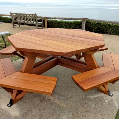 Octagonal Picnic Table (Options: 5' Diameter Tabletop, Attached Benches, California Redwood, Standard Tabletop, 1 5/8" Umbrella Hole, Transparent Premium Sealant). Photo Courtesy of G. Cooley of Dana Point, CA.