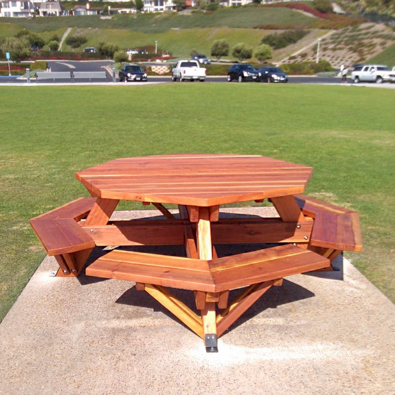 Octagonal Picnic Table (Options: 5 1/2' Diameter Tabletop, Attached Benches, California Redwood, Standard Tabletop, 1 5/8" Umbrella Hole, Transparent Premium Sealant). Photo Courtesy of G. Cooley of Dana Point, CA. Octagonal Picnic Table (Options: 5 1/2' Diameter Tabletop, Attached Benches, California Redwood, Standard Tabletop, 1 5/8" Umbrella Hole, Transparent Premium Sealant). Photo Courtesy of G. Cooley of Dana Point, CA.