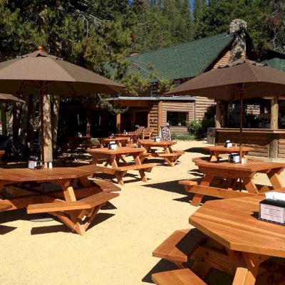 Octagonal Picnic Tables (Options: 6' Diameter Tabletop, Attached Benches, Douglas-fir, Standard Tabletop, Rounded Corners, Umbrella Hole, Transparent Premium Sealant). Forever Picnic Tables Shown in Background.  Photo Courtesy of Jeff C. of Stanley, Idaho.