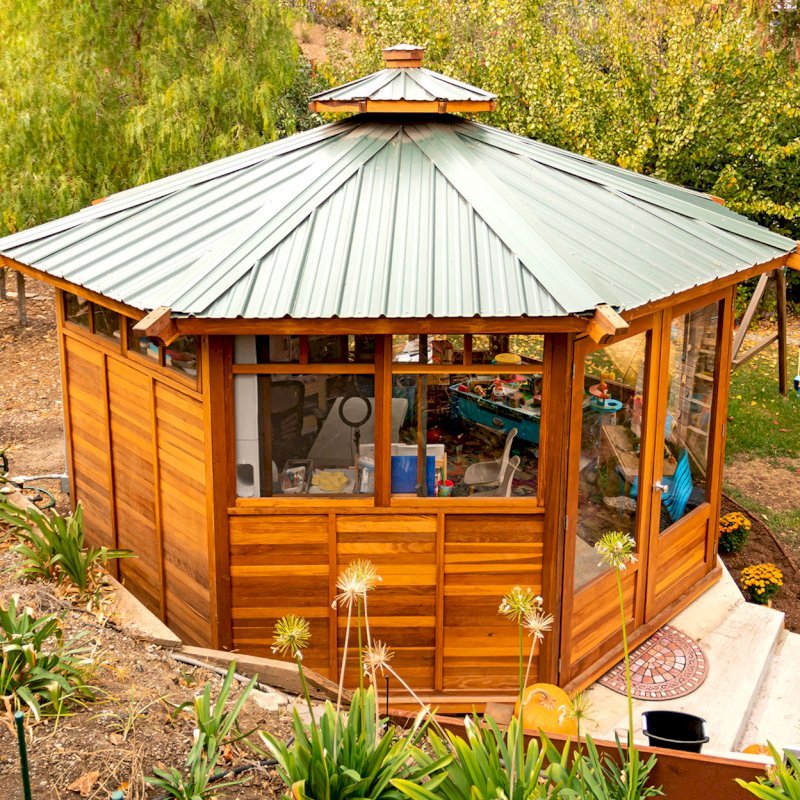 Octagonal Sunroom Gazebo (Options: 16' Diameter, Internal Deck, California Redwood, 24" H Siding Below Windows, 4 Standard Window Panels & 3 Custom Panels, Clear Acrylic, 1 Ceiling Fan Base, 1 Set of Doors, Transparent Premium Sealant). Photo Courtesy of D. Coons of Morgan Hill, California. Octagonal Sunroom Gazebo (Options: 16' Diameter, Internal Deck, California Redwood, 24" H Siding Below Windows, 4 Standard Window Panels & 3 Custom Panels, Clear Acrylic, 1 Ceiling Fan Base, 1 Set of Doors, Transparent Premium Sealant). Photo Courtesy of D. Coons of Morgan Hill, California.
