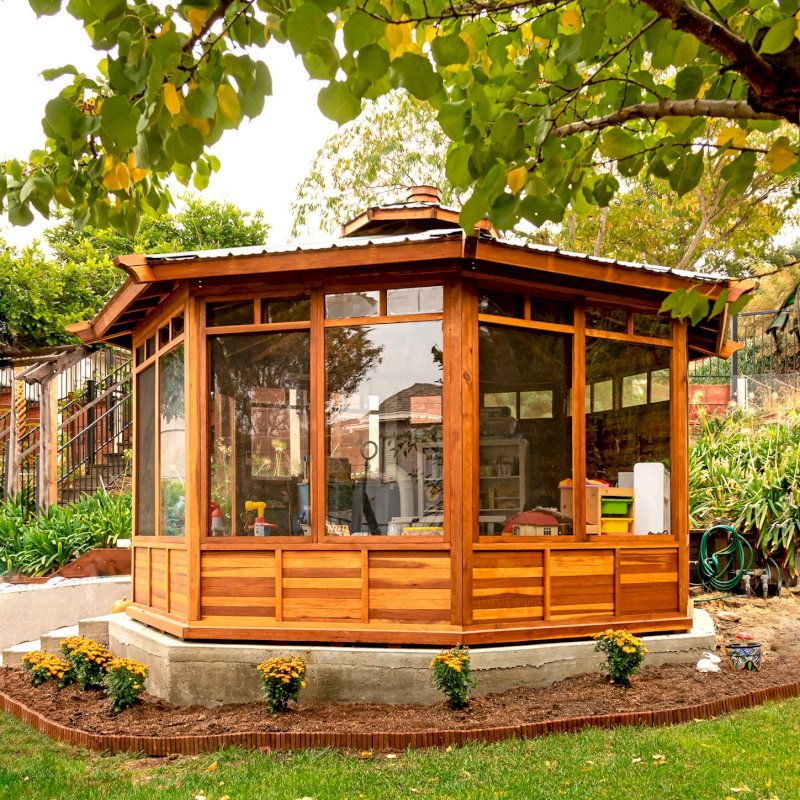Octagonal Sunroom Gazebo (Options: 16' Diameter, Internal Deck, California Redwood, 24" H Siding Below Windows, 4 Standard Window Panels & 3 Custom Panels, Clear Acrylic, 1 Ceiling Fan Base, 1 Set of Doors, Transparent Premium Sealant). Photo Courtesy of D. Coons of Morgan Hill, California. Octagonal Sunroom Gazebo (Options: 16' Diameter, Internal Deck, California Redwood, 24" H Siding Below Windows, 4 Standard Window Panels & 3 Custom Panels, Clear Acrylic, 1 Ceiling Fan Base, 1 Set of Doors, Transparent Premium Sealant). Photo Courtesy of D. Coons of Morgan Hill, California.