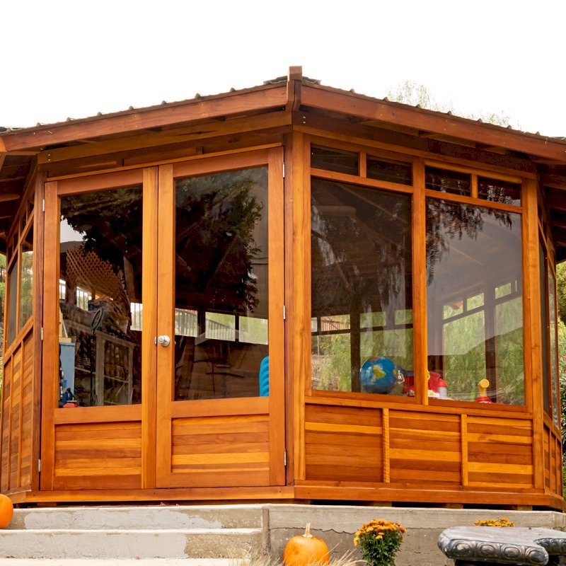 Octagonal Sunroom Gazebo (Options: 16' Diameter, Internal Deck, California Redwood, 24" H Siding Below Windows, 4 Standard Window Panels & 3 Custom Panels, Clear Acrylic, 1 Ceiling Fan Base, 1 Set of Doors, Transparent Premium Sealant). Photo Courtesy of D. Coons of Morgan Hill, California. Octagonal Sunroom Gazebo (Options: 16' Diameter, Internal Deck, California Redwood, 24" H Siding Below Windows, 4 Standard Window Panels & 3 Custom Panels, Clear Acrylic, 1 Ceiling Fan Base, 1 Set of Doors, Transparent Premium Sealant). Photo Courtesy of D. Coons of Morgan Hill, California.