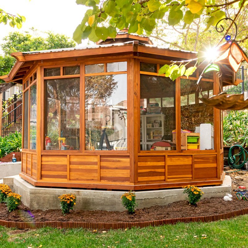 Octagonal Sunroom Gazebo (Options: 16' Diameter, Internal Deck, California Redwood, 24" H Siding Below Windows, 4 Standard Window Panels & 3 Custom Panels, Clear Acrylic, 1 Ceiling Fan Base, 1 Set of Doors, Transparent Premium Sealant). Photo Courtesy of D. Coons of Morgan Hill, California. Octagonal Sunroom Gazebo (Options: 16' Diameter, Internal Deck, California Redwood, 24" H Siding Below Windows, 4 Standard Window Panels & 3 Custom Panels, Clear Acrylic, 1 Ceiling Fan Base, 1 Set of Doors, Transparent Premium Sealant). Photo Courtesy of D. Coons of Morgan Hill, California.