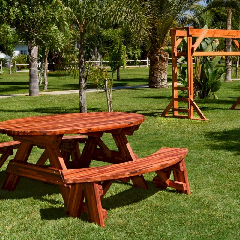 Oval Picnic Table (Options. Oval XL, Unattached Side Benches, Mosaic Eco-Wood, Standard Tabletop, Umbrella Hole, Transparent Premium Sealant). Photo also shows a Monkey Bar in background. Oval Picnic Table (Options. Oval XL, Unattached Side Benches, Mosaic Eco-Wood, Standard Tabletop, Umbrella Hole, Transparent Premium Sealant). Photo also shows a Monkey Bar in background.