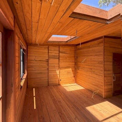 Custom Palo Alto Backyard Cabin (Options: 18' L, 16' W, With 19' x 19' Structural Deck with Steps, California Redwood for Exterior Finished, Douglas-fir Internal Walls and Framing, Double Door, Slidding Windows, Windows Purchased Locally, With Two 2' x 2' Skylights, Metal Roof, Electrical Wire Trim on the Walls, Transparent Premium Sealant). Photo Courtesy of R. & M. Hegwood of Ceres, CA.