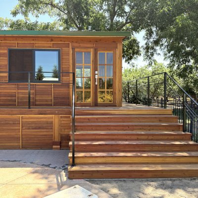 Custom Palo Alto Backyard Cabin (Options: 18' L, 16' W, With 19' x 19' Structural Deck with Steps, California Redwood for Exterior Finished, Douglas-fir Internal Walls and Framing, Double Door, Slidding Windows, Windows Purchased Locally, With Two 2' x 2' Skylights, Metal Roof, Electrical Wire Trim on the Walls, Transparent Premium Sealant). Photo Courtesy of R. & M. Hegwood of Ceres, CA.
