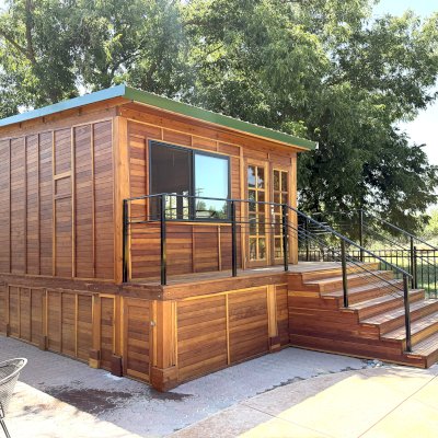 Custom Palo Alto Backyard Cabin (Options: 18' L, 16' W, With 19' x 19' Structural Deck with Steps, California Redwood for Exterior Finished, Douglas-fir Internal Walls and Framing, Double Door, Slidding Windows, Windows Purchased Locally, With Two 2' x 2' Skylights, Metal Roof, Electrical Wire Trim on the Walls, Transparent Premium Sealant). Photo Courtesy of R. & M. Hegwood of Ceres, CA.