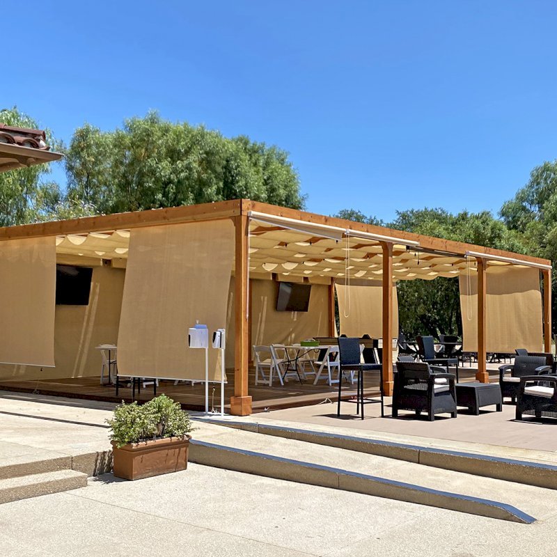 Retractable Canopy Pergola (Options: 24' W x 40' L, Douglas-fir, 8-post kit for Concrete, Transparent Premium Sealant). Photo Courtesy of El Paseo Tennis Club of Valencia, CA. Retractable Canopy Pergola (Options: 24' W x 40' L, Douglas-fir, 8-post kit for Concrete, Transparent Premium Sealant). Photo Courtesy of El Paseo Tennis Club of Valencia, CA.