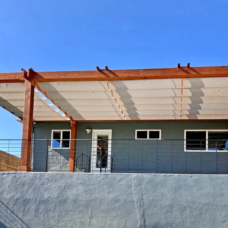 Retractable Canopy Pergola (Options: 30' L x 12' W, No Privacy Panel, Mature Redwood, 8 x 8 Posts by Custom Request, 10 ft Post Height, No Electrical Wiring Trim, Post Anchor Kit for Concrete, No Post Decorative Trim, No Ceiling Fan Base, No Curtain Rods, Transparent Premium Sealant, Overhang of Supports by Custom Request). Photo Courtesy of J. Herr of Venice, CA. Retractable Canopy Pergola (Options: 30' L x 12' W, No Privacy Panel, Mature Redwood, 8 x 8 Posts by Custom Request, 10 ft Post Height, No Electrical Wiring Trim, Post Anchor Kit for Concrete, No Post Decorative Trim, No Ceiling Fan Base, No Curtain Rods, Transparent Premium Sealant, Overhang of Supports by Custom Request). Photo Courtesy of J. Herr of Venice, CA.