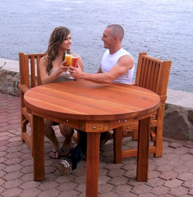 Round Outdoor Patio Table (Options: 4', 4 Chairs (only 2 shown in the picture), Redwood, Ruth Chairs, No Cushions, Arm Chairs only, Seamless tabletop, No Lazy Susan, No Umbrella Hole, Transparent Premium Sealant). 