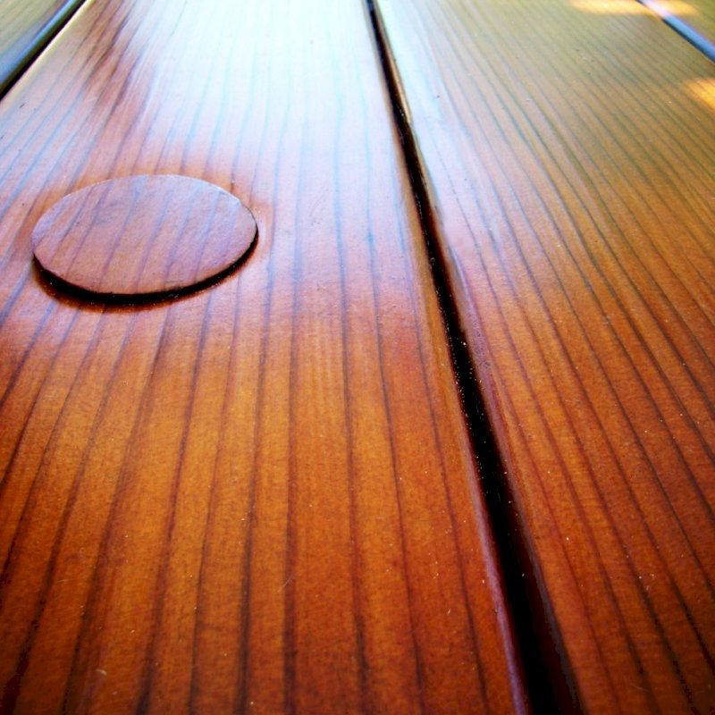 Closeup of tabletop highlighting the exquisite quality of the vertical grain lumber and the Transparent Premium Sealant - Mature Redwood. Closeup of tabletop highlighting the exquisite quality of the vertical grain lumber and the Transparent Premium Sealant - Mature Redwood.