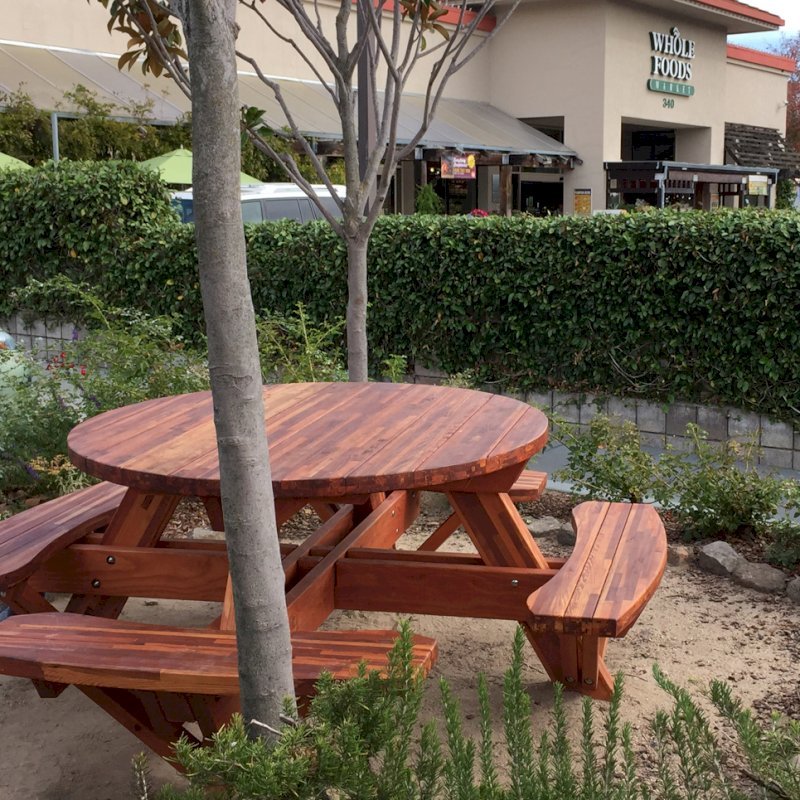 Round Wooden Picnic Tables (Attached Benches) (Options: 5' Diameter, Attached Benches, Mosaic Eco-Wood, Standard Tabletop, No Lazy Susan, Umbrella Hole & Plug, Transparent Premium Sealant). Photo Courtesy of Whole Foods Market of San Rafael, CA. Round Wooden Picnic Tables (Attached Benches) (Options: 5' Diameter, Attached Benches, Mosaic Eco-Wood, Standard Tabletop, No Lazy Susan, Umbrella Hole & Plug, Transparent Premium Sealant). Photo Courtesy of Whole Foods Market of San Rafael, CA.