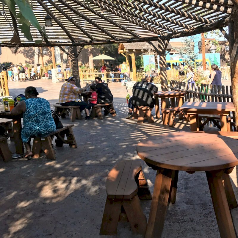 Round Wooden Picnic Tables with Picnic Benches Installed in Knott's Berry Farm in Buena Park, California. Photo Also Shows Some Square Patio Table Sets with Benches. Round Wooden Picnic Tables with Picnic Benches Installed in Knott's Berry Farm in Buena Park, California. Photo Also Shows Some Square Patio Table Sets with Benches.
