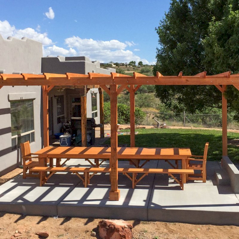 San Francisco Redwood Patio Table under a Garden Pergola (Options: 14'L, 46" W Tabletop, Benches & End Armchairs, Douglas-fir, Ruth, No Cushion, Classic Picnic Benches, 1 Full Length Bench Per Side, Standard Tabletop, Squared Corners, No Umbrella Hole, Transparent Premium Sealant). Photo Courtesy of Chris D. of Cornville Arizona. San Francisco Redwood Patio Table under a Garden Pergola (Options: 14'L, 46" W Tabletop, Benches & End Armchairs, Douglas-fir, Ruth, No Cushion, Classic Picnic Benches, 1 Full Length Bench Per Side, Standard Tabletop, Squared Corners, No Umbrella Hole, Transparent Premium Sealant). Photo Courtesy of Chris D. of Cornville Arizona.