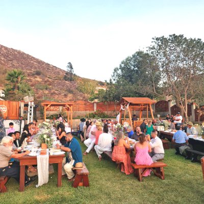 Photo Shows Several Forever Redwood Tables, a Small Lattice Pergola and a Dustin's Face to Face Glider.